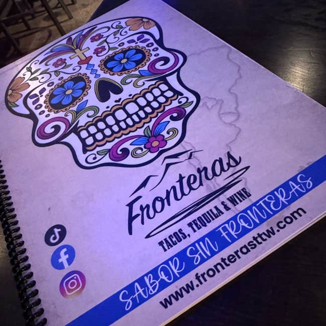 Sugar skull colorful artwork on the cover of Fronteras menu