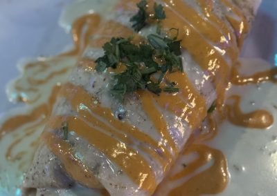 Fronteras Restaurant - Sriracha Burrito is a big burrito filled with steak, white rice, whole pinto beans and pico de gallo. Covered with melted cheese and Fronteras' special sriracha sauce.