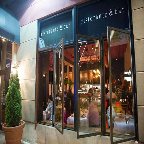 Outdoor Covered Patio of Z Cucina with draped lights and cloth drapes tied back